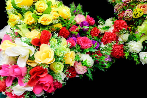 bouquet of colorful artificial flowers on black background